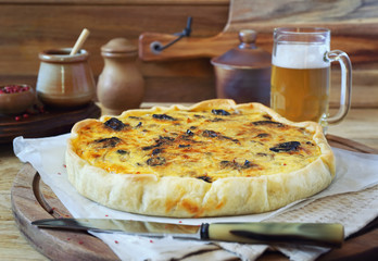 Zwiebelkuchen with prunes and mug of beer