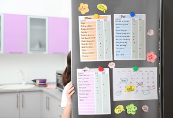 Calendar and to do lists hanging on refrigerator