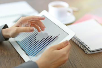 Female hands holding tablet with business diagram