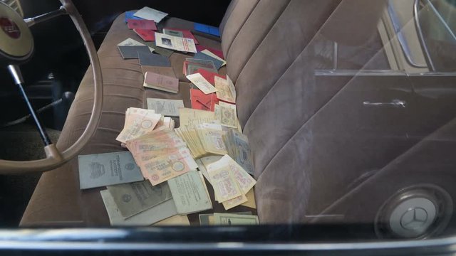 Scattered old Russian money bills on the car found on the front seat of the old car