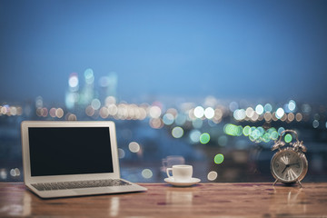Laptop, alarm clock and coffee