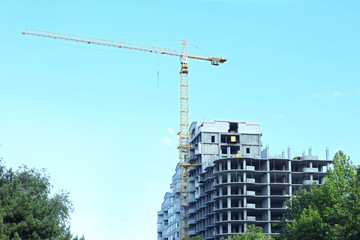 Crane and building construction on sky background