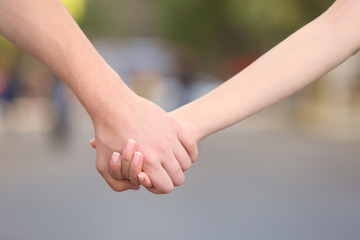 Couple holding hands, close up