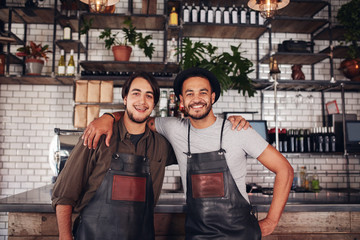 Happy young male bartenders