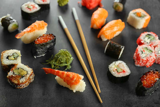 Sushi set and chopsticks on dark background