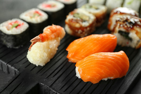 Sushi set on wooden board, close up