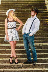 Loving couple retro style flirting on stairs