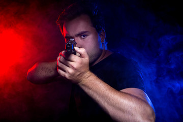 Cop shooting a criminal or terrorist with gun smoke lit by police lights