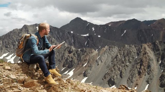 man working outdoors with tablet computer