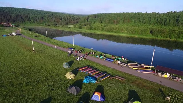 tourist camp, boat, river and forest aerial view in summer morning