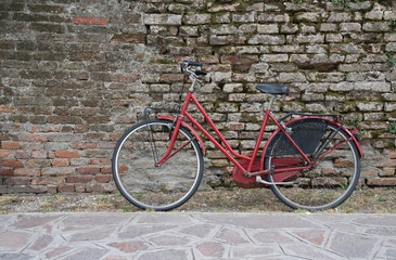Fototapeta na wymiar Bicycle along brick wall