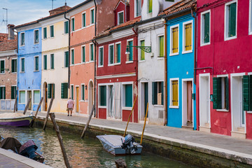 Fototapeta na wymiar Colorful homes along canal in Burano, Italy