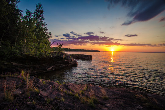 Sunset On The Shores Of Lake Superior. Sunset on the shores of Lake Superior outside of L'Anse Michigan at the Point Abbaye Nature Sanctuary.