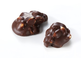 Chocolate pieces with nuts on a white background