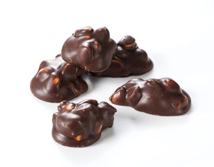 Chocolate pieces with nuts on a white background