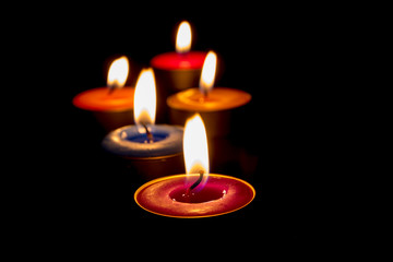 Burning candles on a dark background with warm light