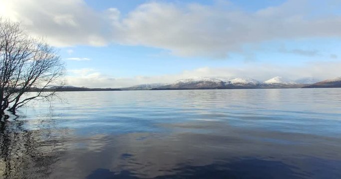 Aerial: Loch Tay in the Scottish Highlands during a clear winters day with snow on Ben Lawers, Scotland