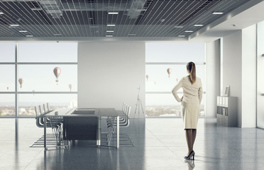 Businesswoman in modern office interior  . Mixed media