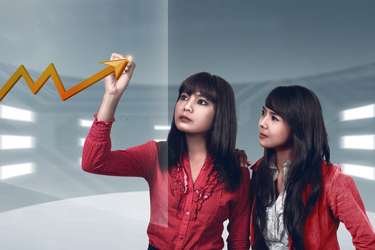 Asian business woman drawing chart on virtual screen