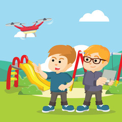 boy and his friend playing drone at park