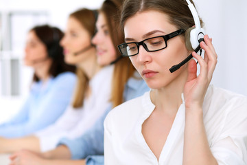 Call center operator.Young beautiful business woman in headset.
