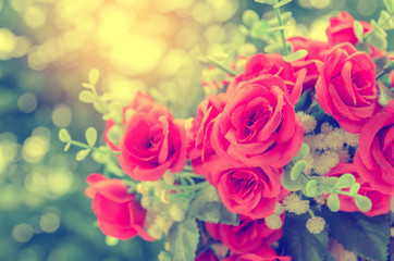 bunch of red rose flower on table with nature blur background
