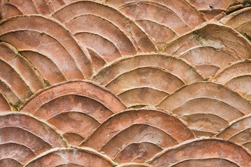closeup old orange fish scales pattern on the wall texture background © a3701027
