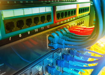 network cables and hub closeup with fiber optical background