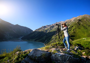 Tourist woman at the mountains at sunrise