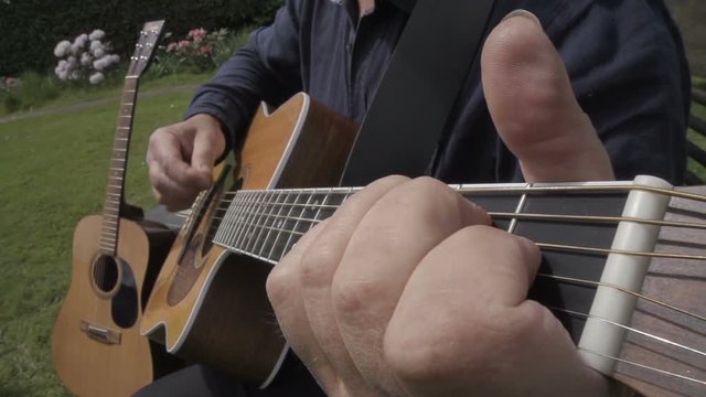 Male Playing The Acoustic Guitar In Slow Motion