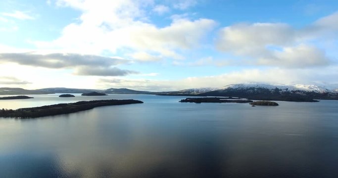 Aerial: Loch Tay in the Scottish Highlands during a clear winters day with snow on Ben Lawers, Scotland