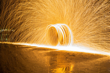 Spin fire show on the beach,Long exposure, art of fire show on t