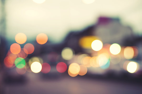 Artistic style - Defocused urban abstract blurred bokeh lights. City blurring light in the background for your design, vintage or retro color tone style.