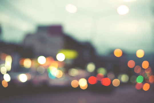 Artistic style - Defocused urban abstract blurred bokeh lights. City blurring light in the background for your design, vintage or retro color tone style.