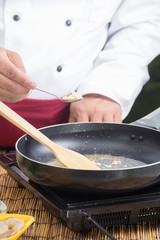 Chef putting minced garlic for cooking Pad Thai
