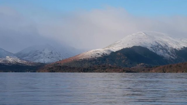 Aerial: Loch Tay in the Scottish Highlands during a clear winters day with snow on Ben Lawers, Scotland