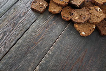 Wooden background with rye bread slices, copyspace. Rustic bakery workplace, free space for text or advertisement