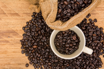coffee bean with bean sack and cup on wood background