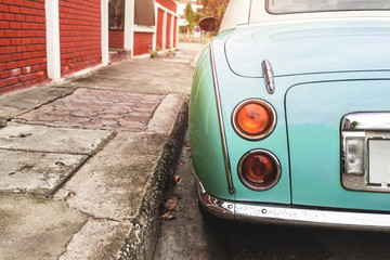 Rear view of classic car parked on street in city - vintage retro color effect styles