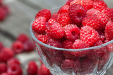 bowl with raspberries on a wooden table