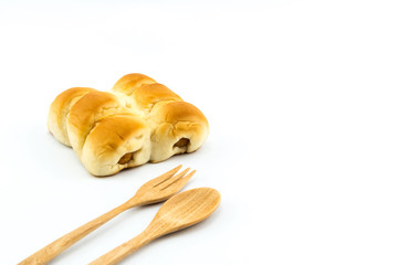Sausage bread and wooden spoon on white background