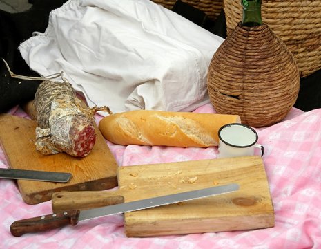 outdoor picinc with salami, bread and big knife and flask