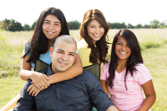 Hispanic Father And His Daughters.