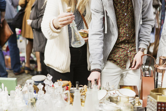 Man and woman buying crockery at flea market