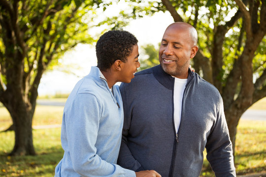 African American father and son talking.