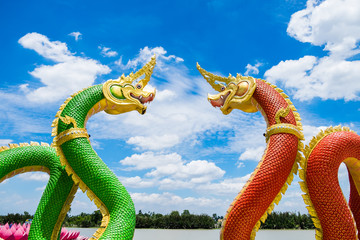 Statue naga mythology green red facing curve and blue sky in wat saman temple