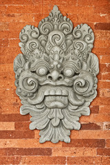 Stone bas-relief on the brick wall. Indonesia, Bali.