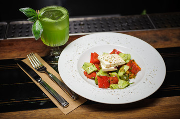 Fresh healthy greek salad on wooden table. View from above  setting