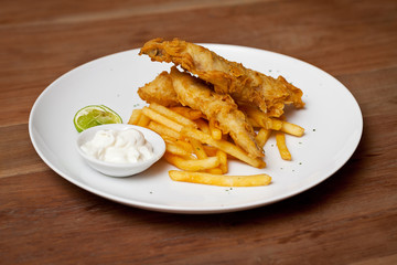 Shrimp tempura dish with white sauce and fried potatoes