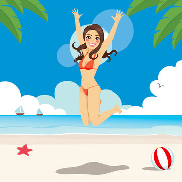 Beautiful brunette woman in bikini jumping happy on the beach